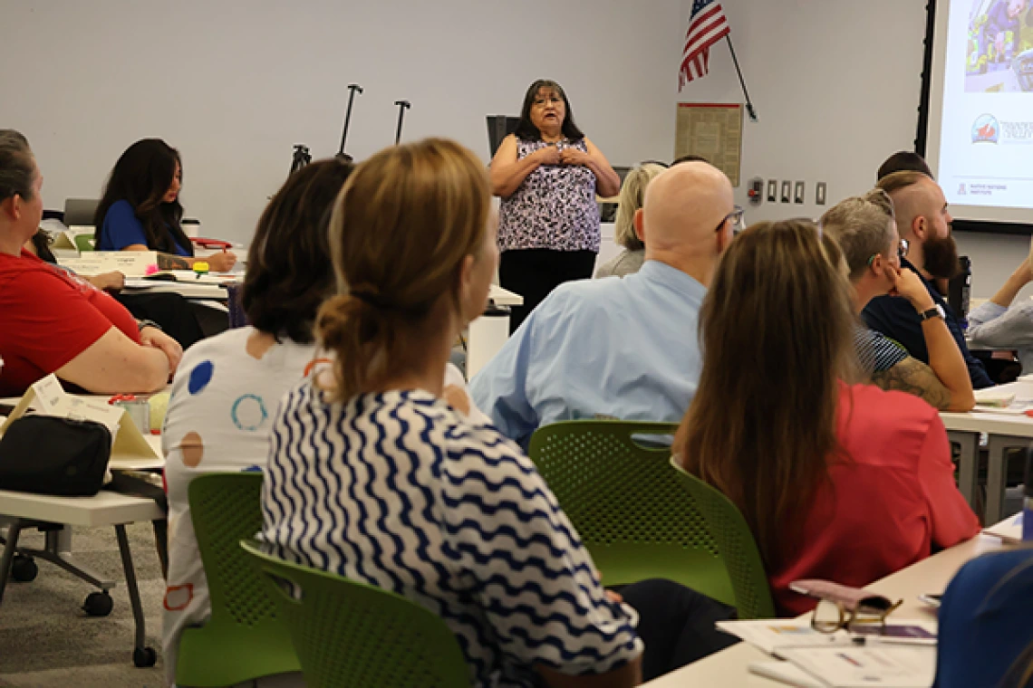 Joan Timeche delivers content at Native Know-How 2025, as seen from the back of the classroom with several seminar attendees in the foreground