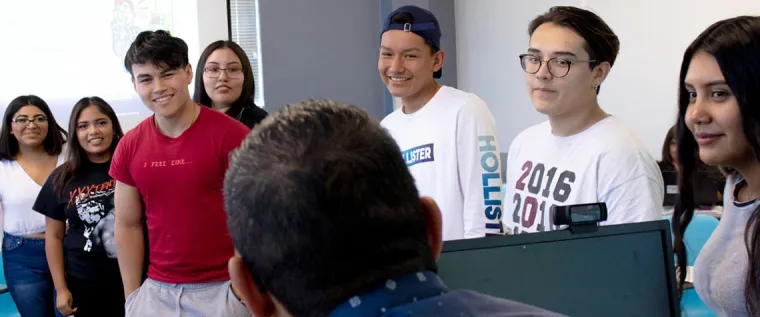 Torin Jacobs II smiles in a red t-shirt while learning amongst his NAYEP cohort.
