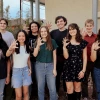 2024 Mo's Policy Scholars pose outside the Udall Center while giving the Wildcats hand signal.