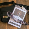 A black fanny pack with the Sacred Path logo and a lanyard from the 2024 Pascua Yaqui Tribal Enrollment Conference.