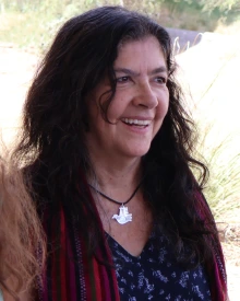 Marcela Vasquez-Leon smiles in an outdoor candid portrait