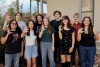 2024 Mo's Policy Scholars pose outside the Udall Center while giving the Wildcats hand signal.